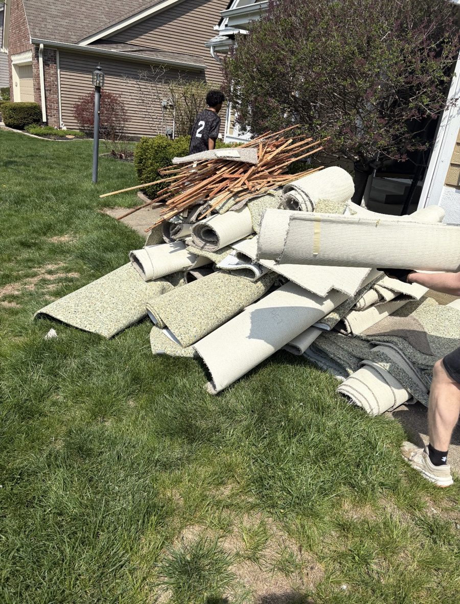 Before: old carpet pulled up and piled on lawn