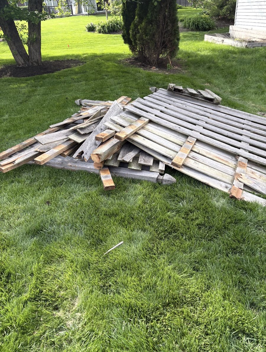 Before: dismantled fence and deck wood pile